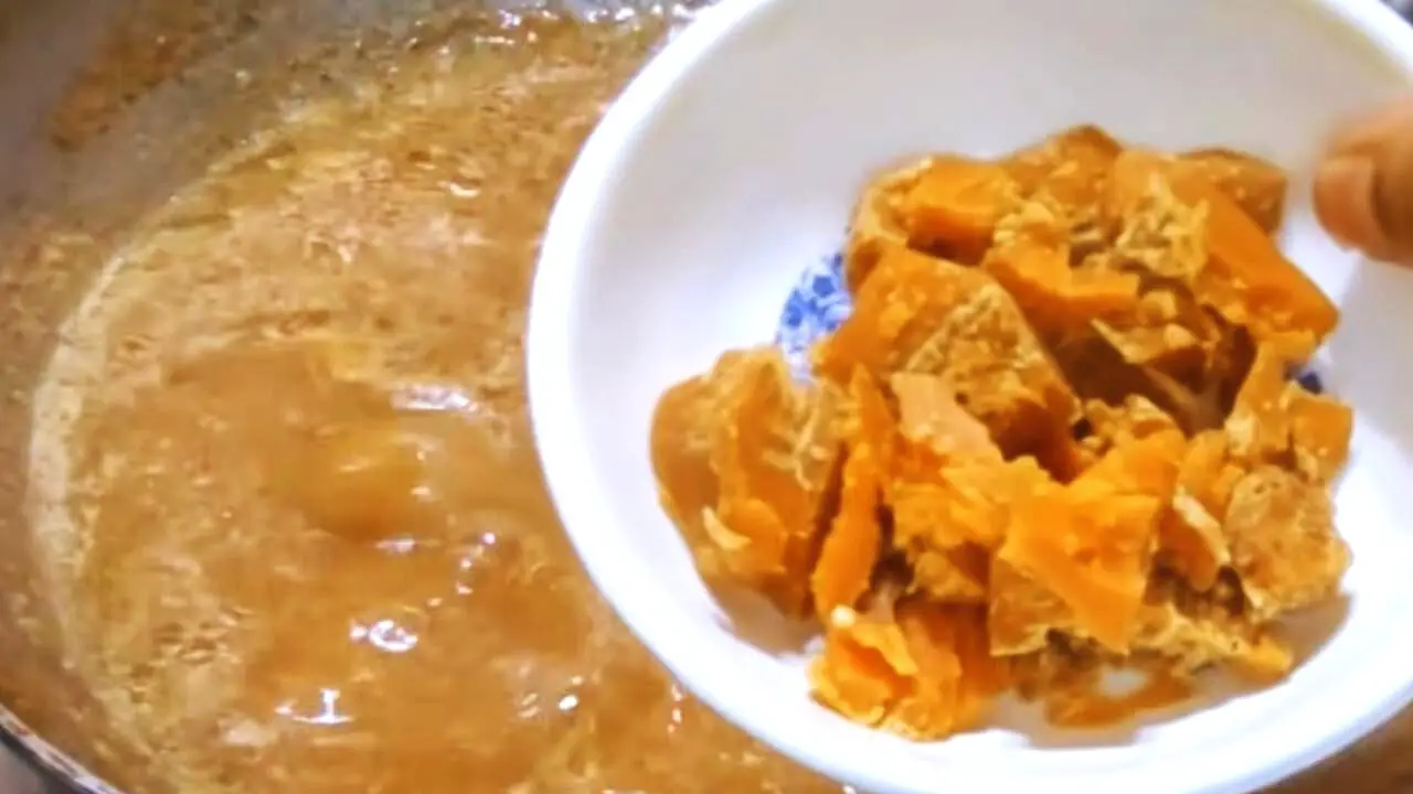 Adding jaggery to tamarind chutney paste 