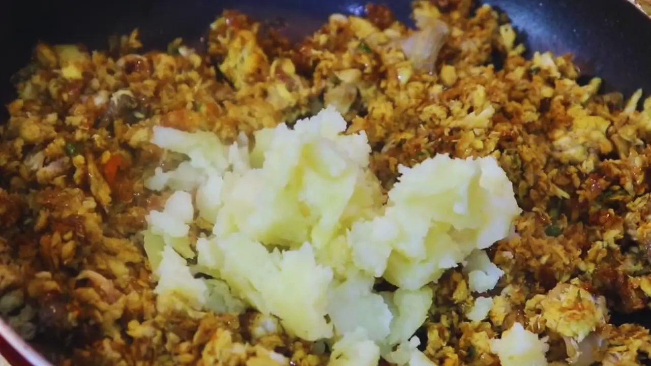Adding mashed potato to Fish Chop ingredients 