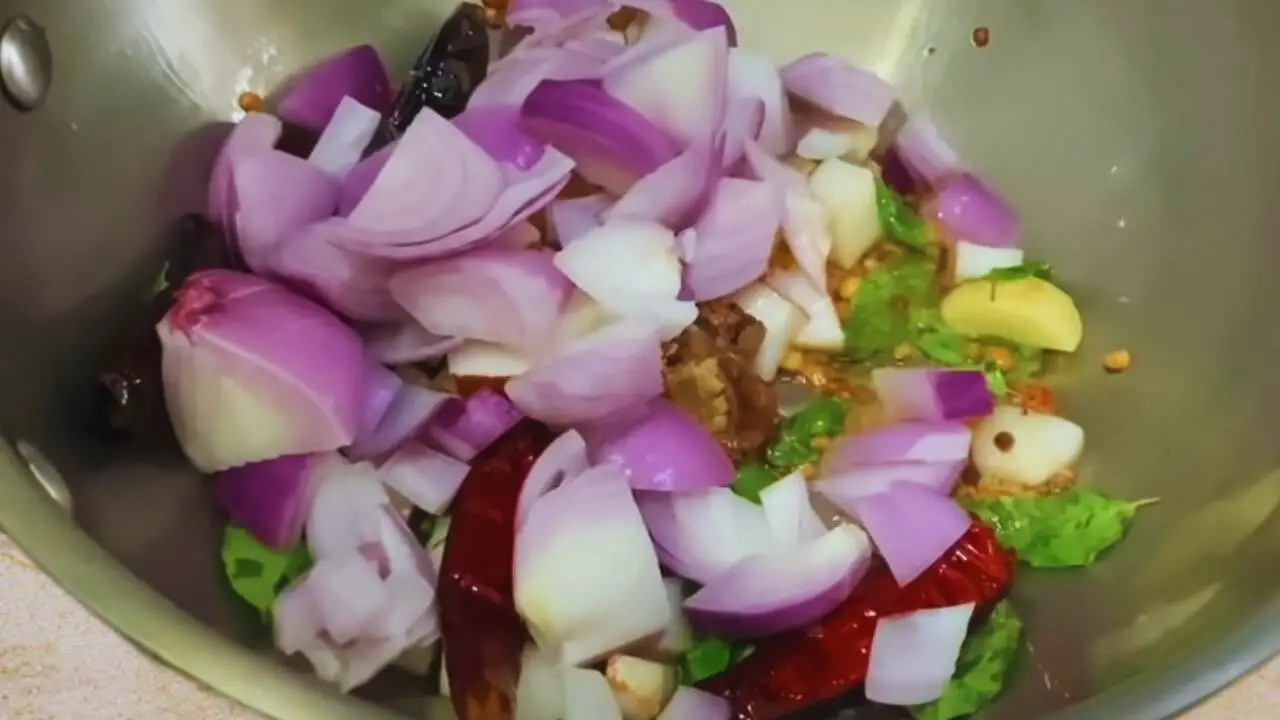 Adding onion to Chow Chow Chutney ingredients