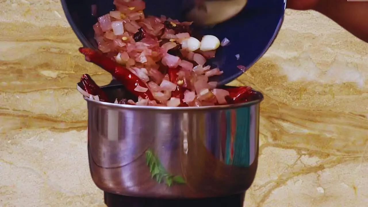 Adding other cooked ingredients of peanut chutney 