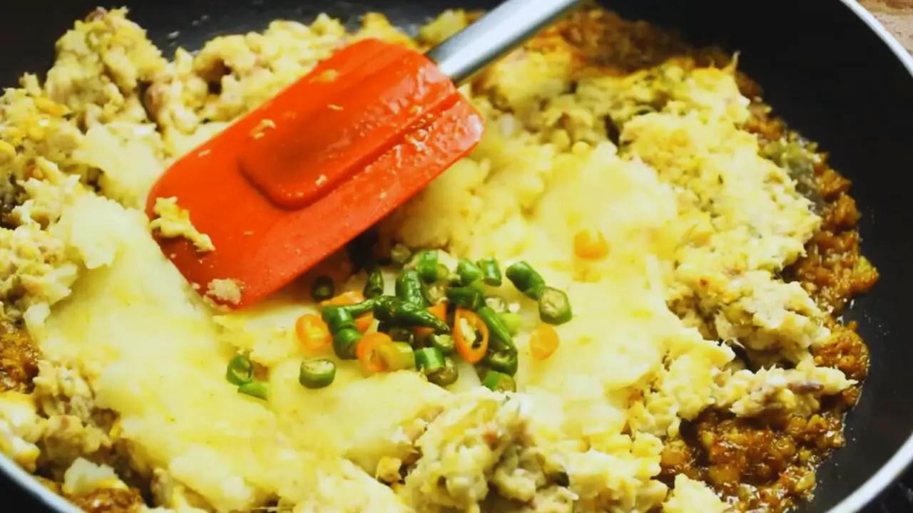 Adding potato and green chilies