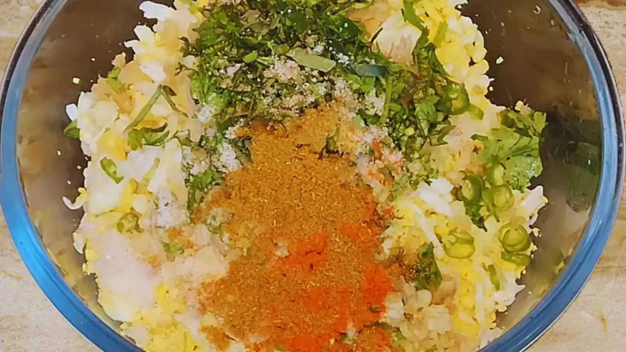 Adding powdered masala to Egg Cutlet mixture 
