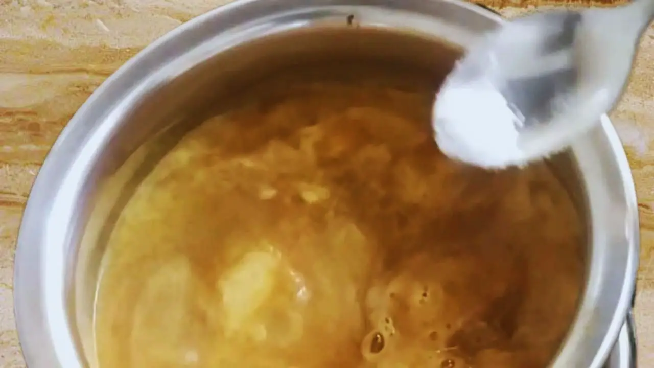 Adding salt to Date Chutney 
