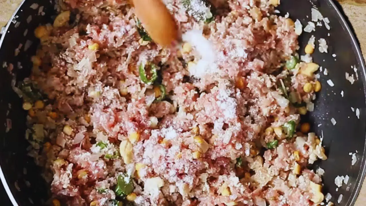 Adding salt to Mutton Keema Balls ingredients 