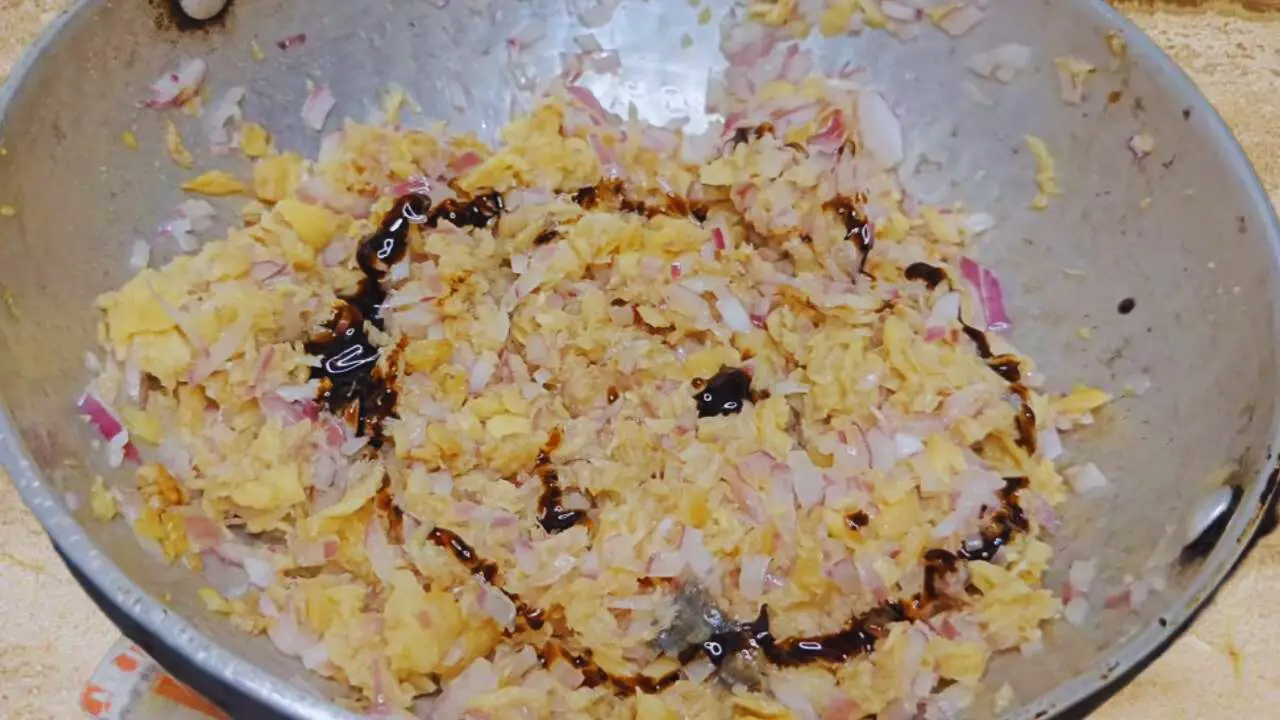 Adding soy sauce to Fish Momo ingredients 