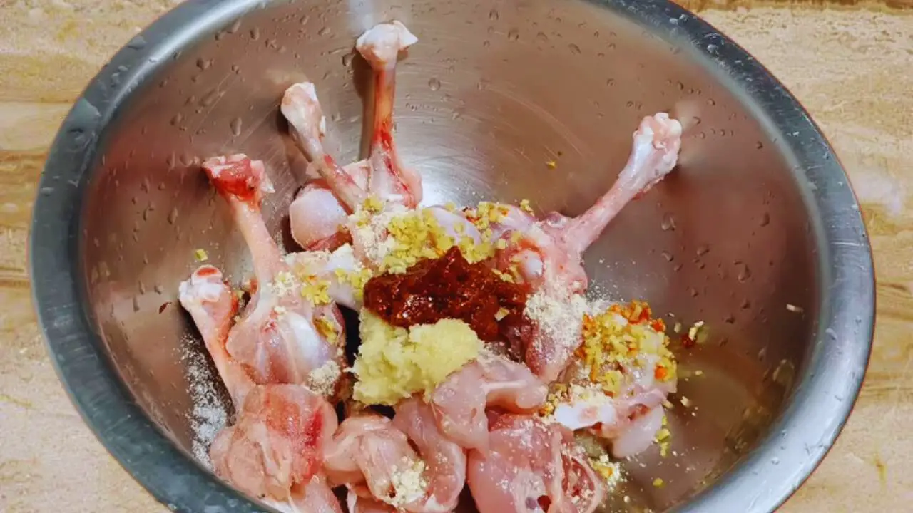 Adding spices to make chicken lollipop