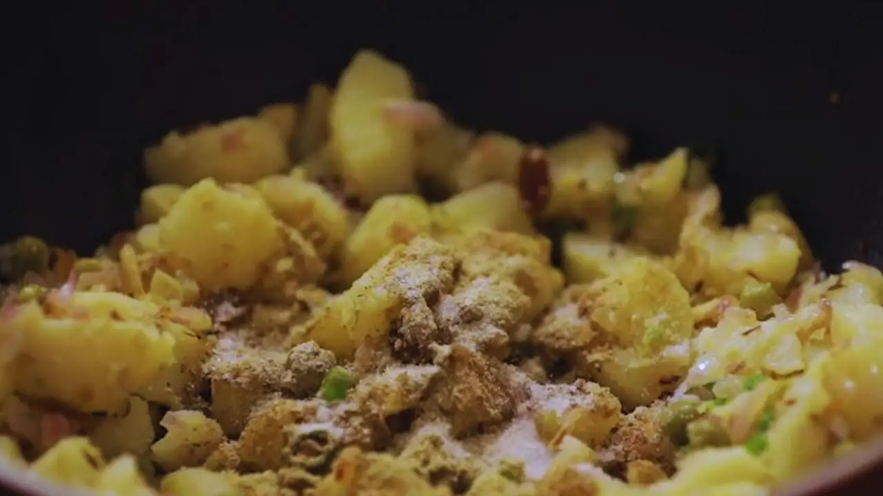 Adding spices to Vegetable Samosa mixture 