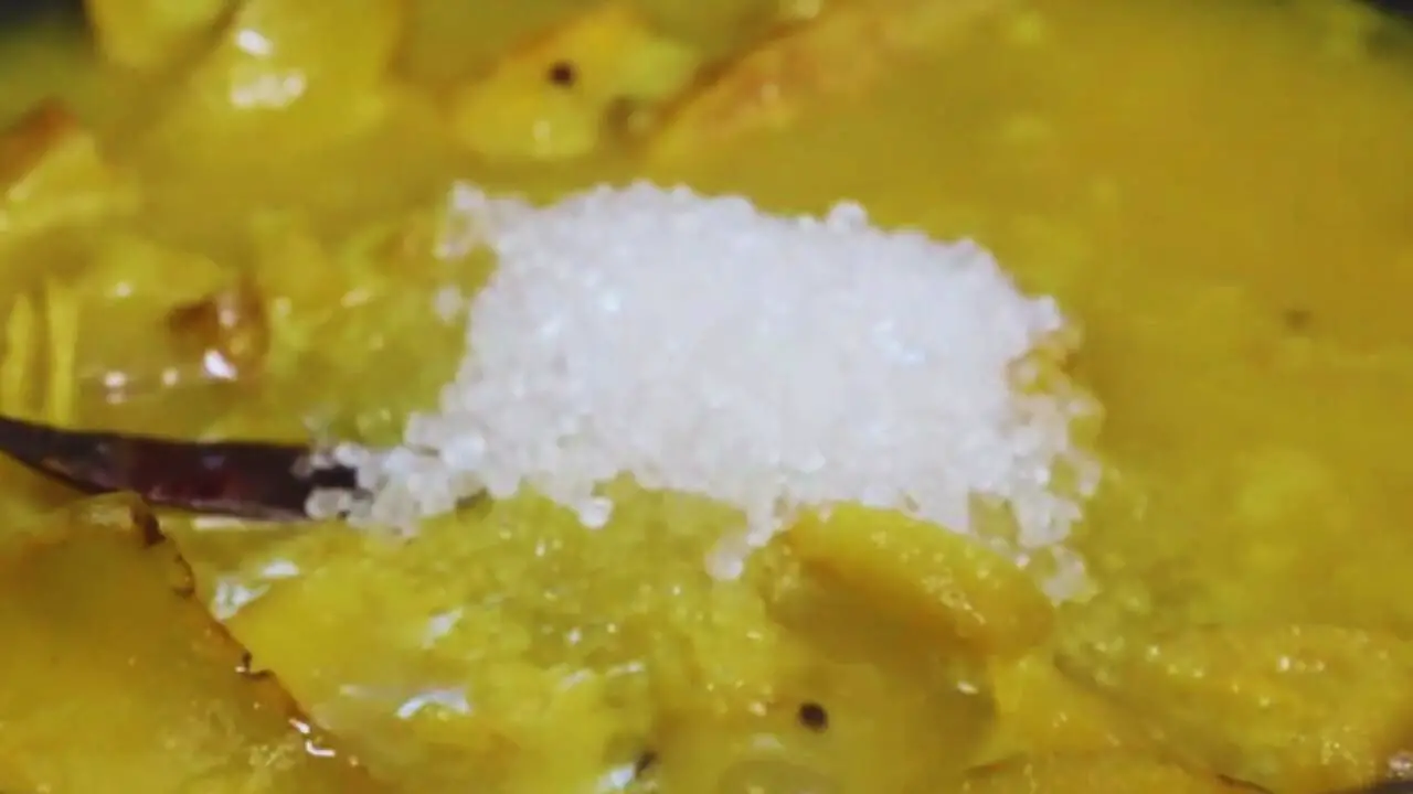 Adding sugar to Elephant Apple Chutney 