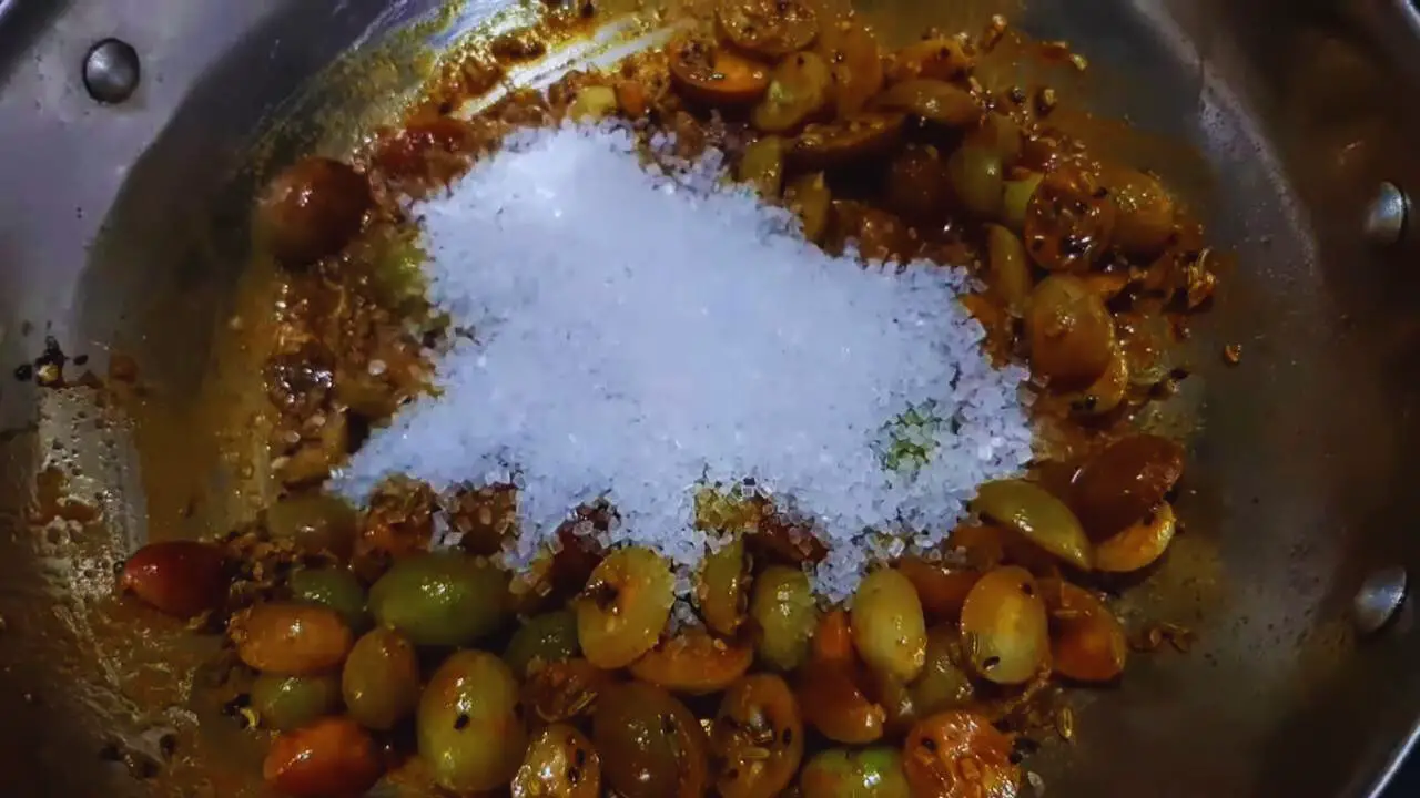 Adding sugar to Karonda Chutney 