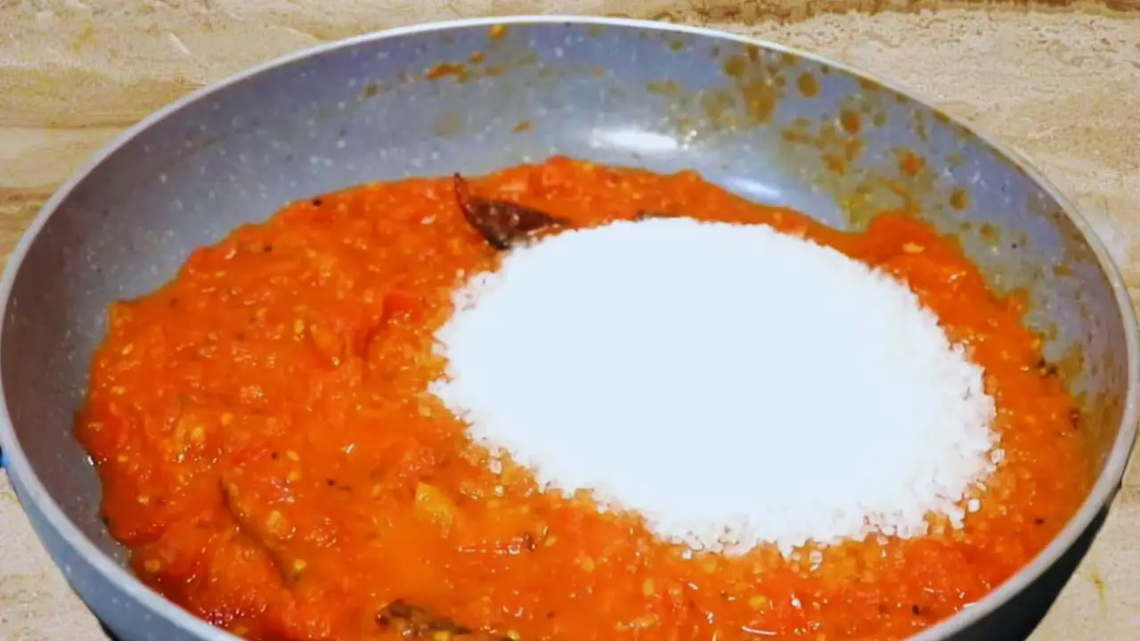 Adding sugar to tomato chutney