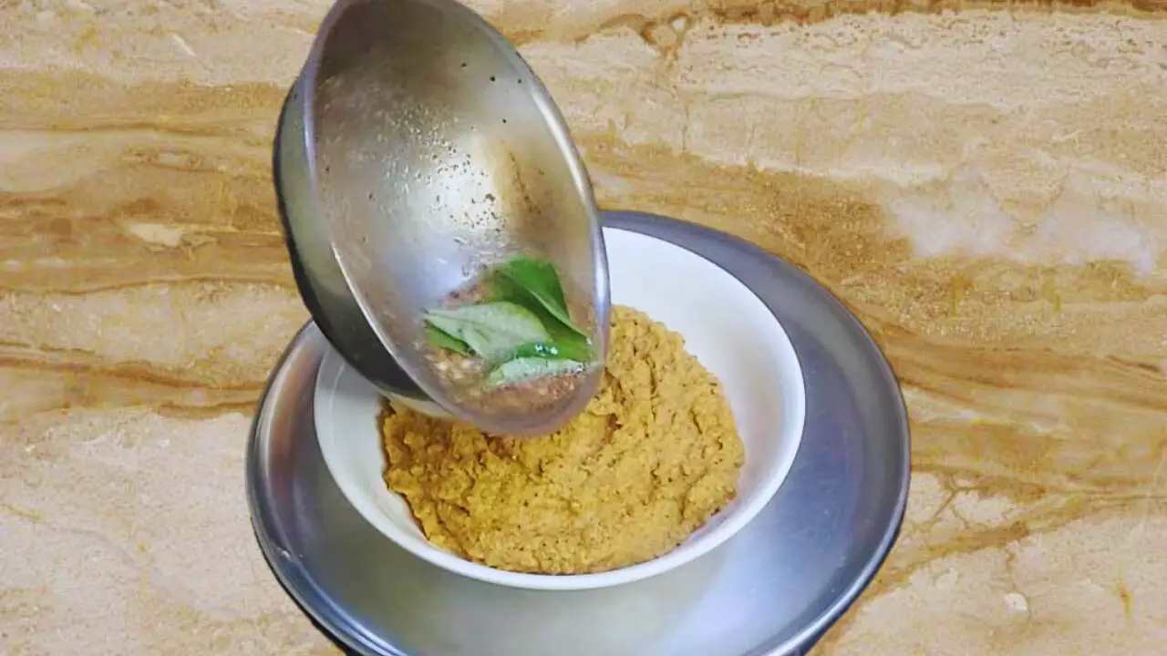 Adding tadka to Cauliflower Chutney paste 