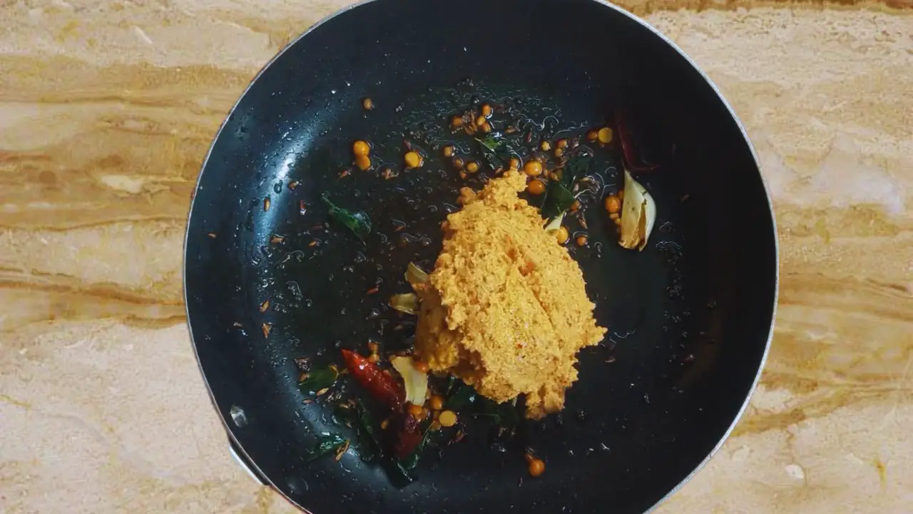 Adding the paste to the fried ingredients 