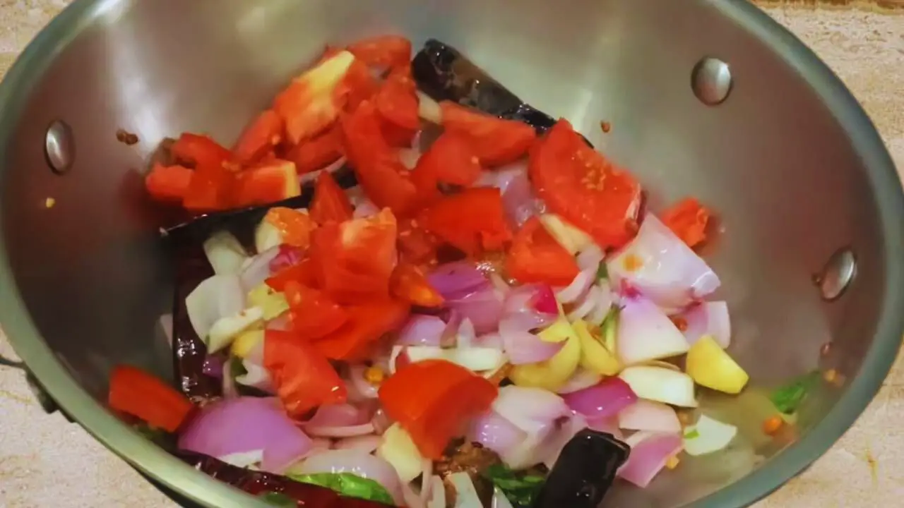 Adding tomato to Chow Chow Chutney ingredients 