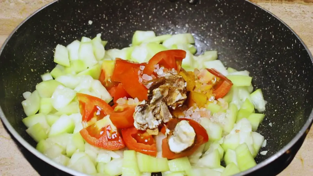 Adding tomatoes and tamarind to make Bottle Gourd Chutney 