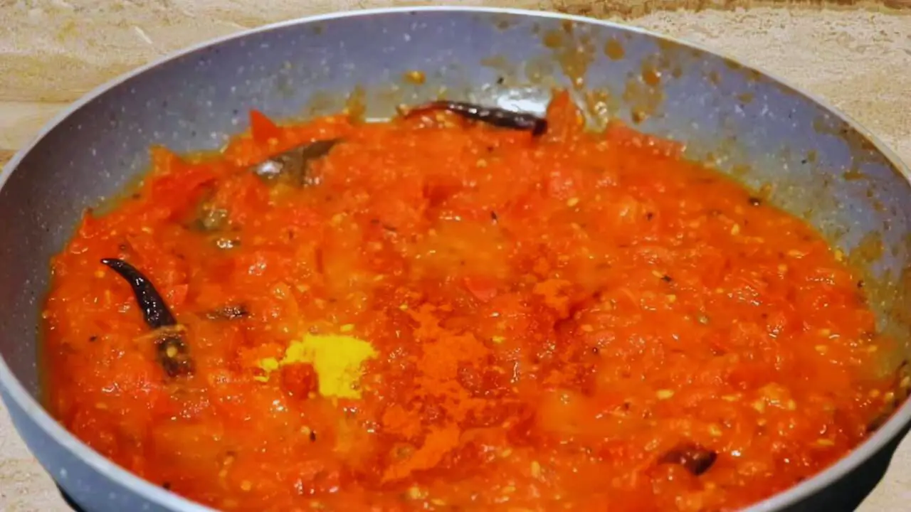 Adding turmeric and Kashmiri red chili powder