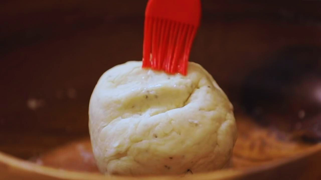 Brushing the dough for Vegetable Samosa with oil