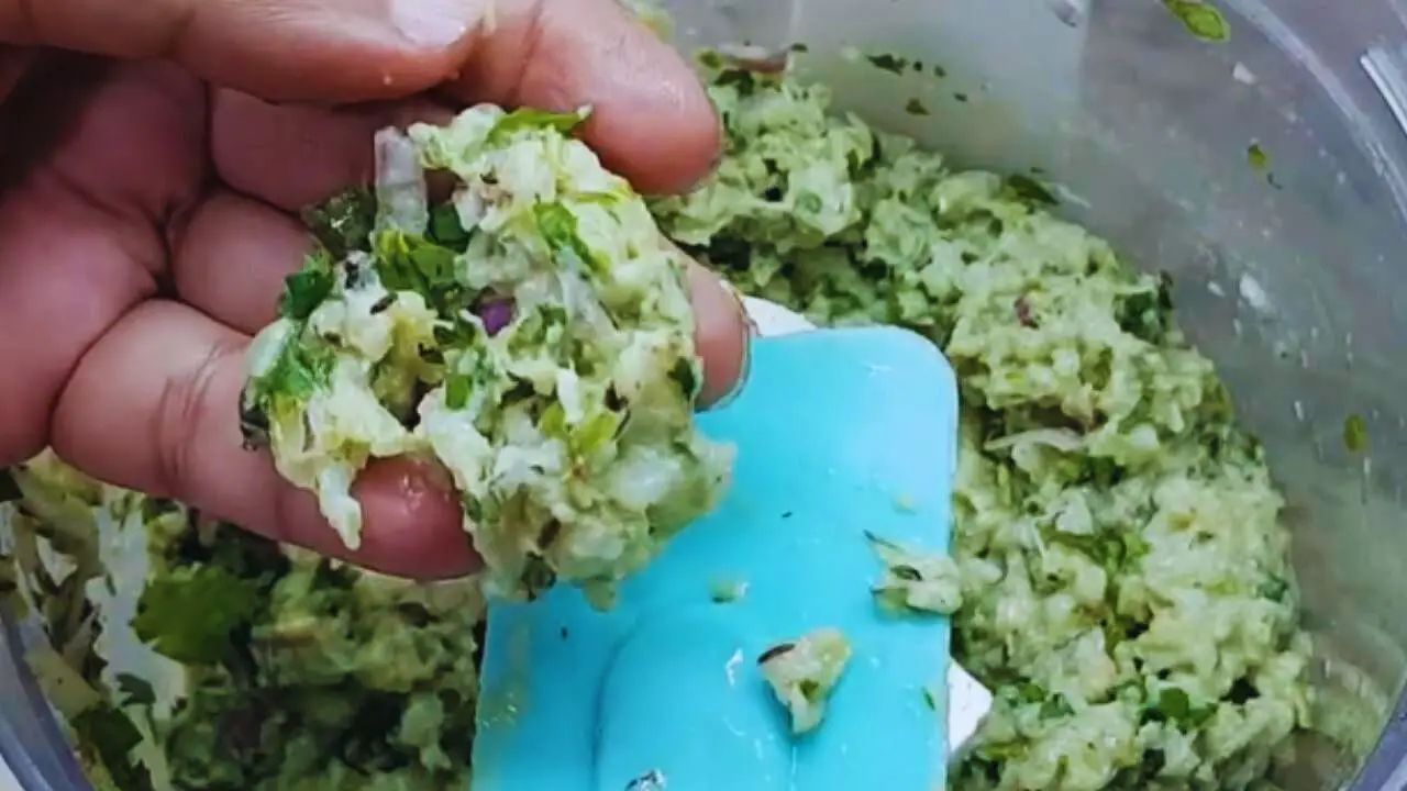 Checking texture of prawn kabab mixture 