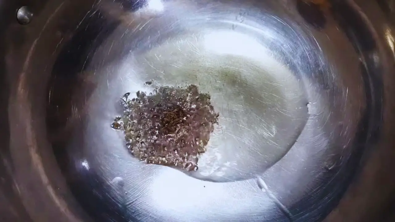 Frying cumin seeds 
