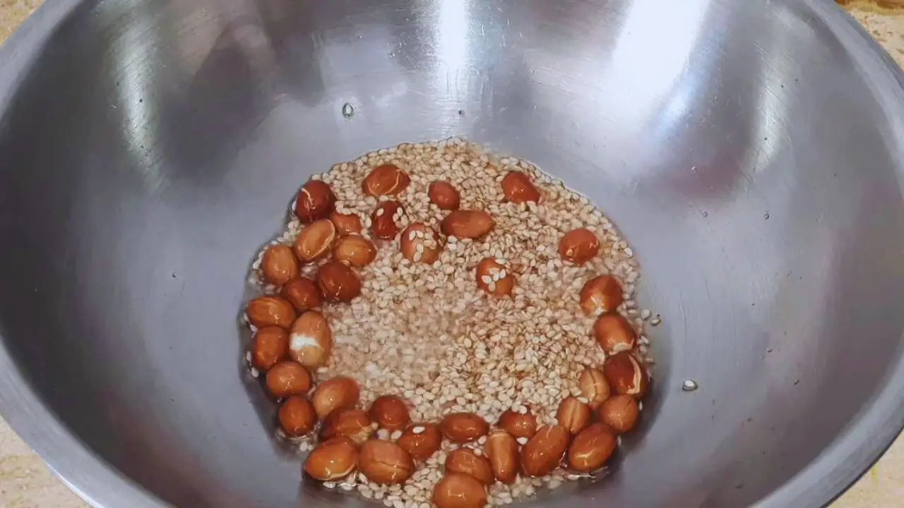 Frying peanuts and sesame seeds to make Green Tomato Chutney 