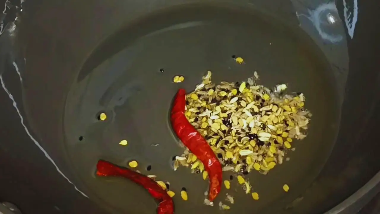 Frying the additional spices to make Jalpai Chutney 