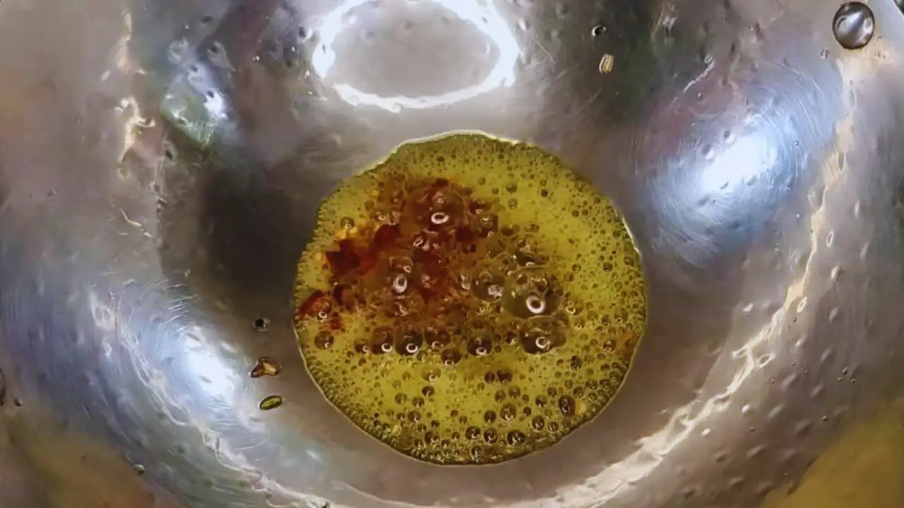 Frying the spices to make Hog Plum Chutney 