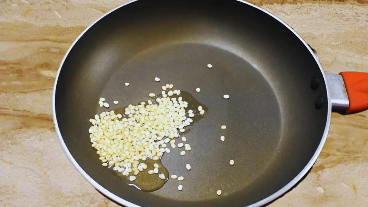 Frying urad dal to make Walnut Chutney 