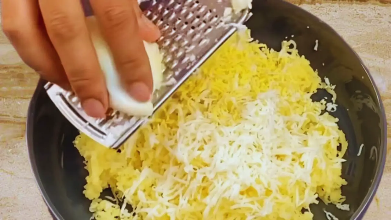 Grating eggs and potatoes to make kabab