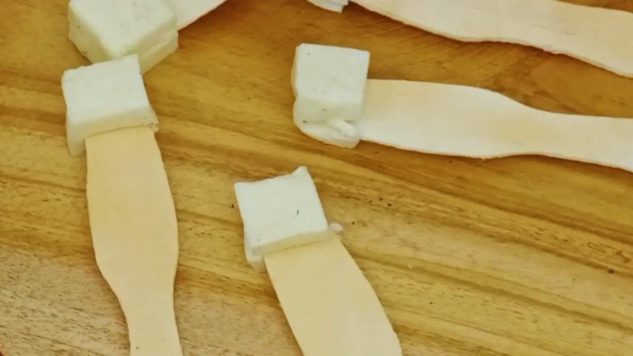 Ice cream sticks and cheese cubes to make mutton lollipop