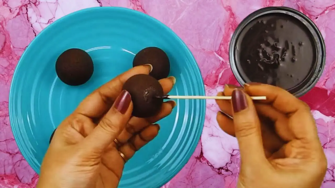 Inserting toothpick in the chocolate ball