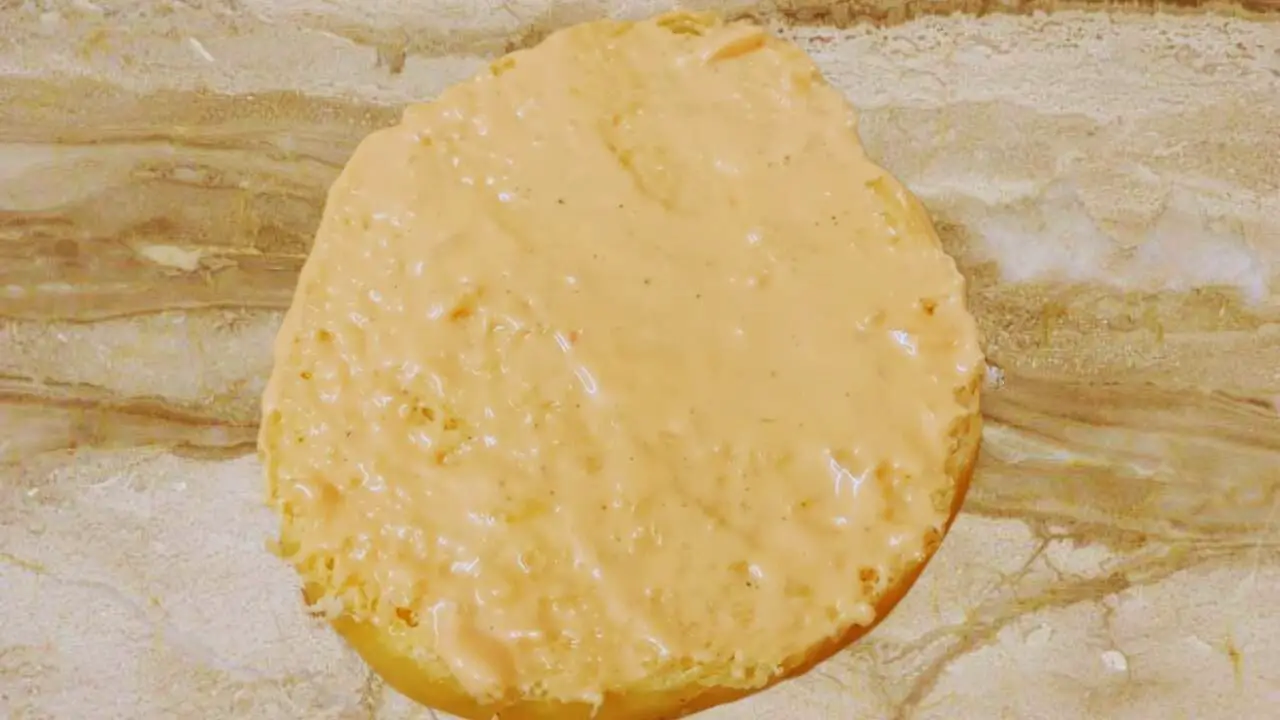 Mayonnaise applied on one-half of burger bun