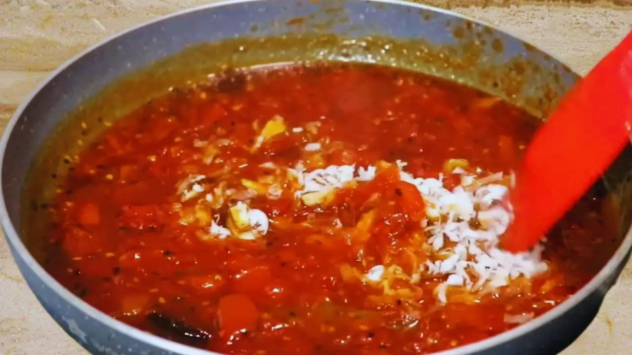 Mixing dry fruits with tomato chutney