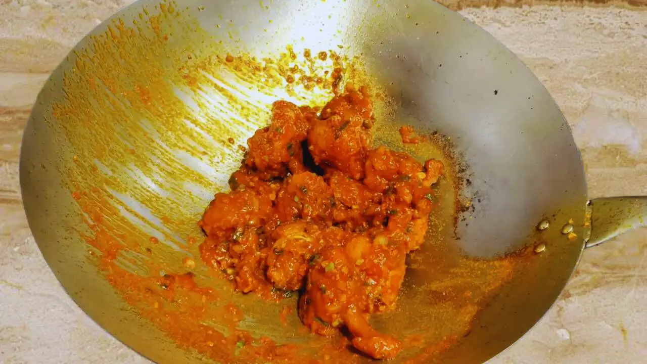 Mixing sauce with chicken lollipops
