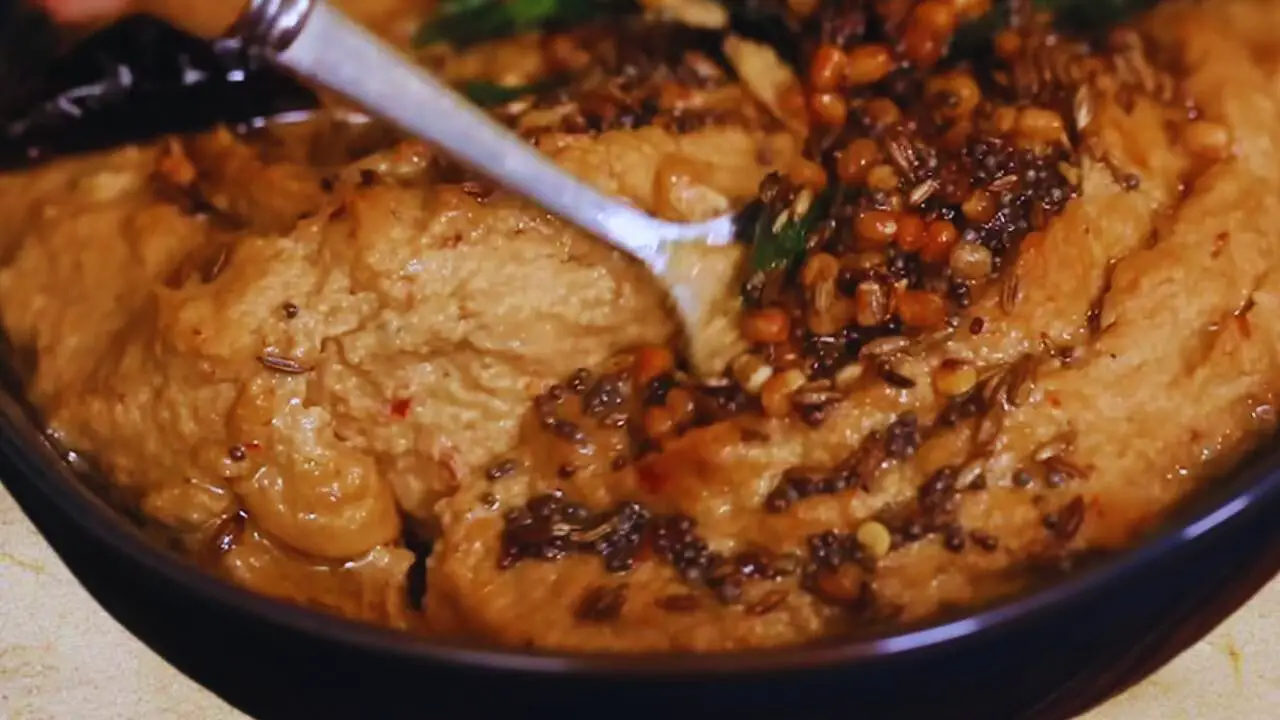 Mixing tadka with peanut chutney paste 