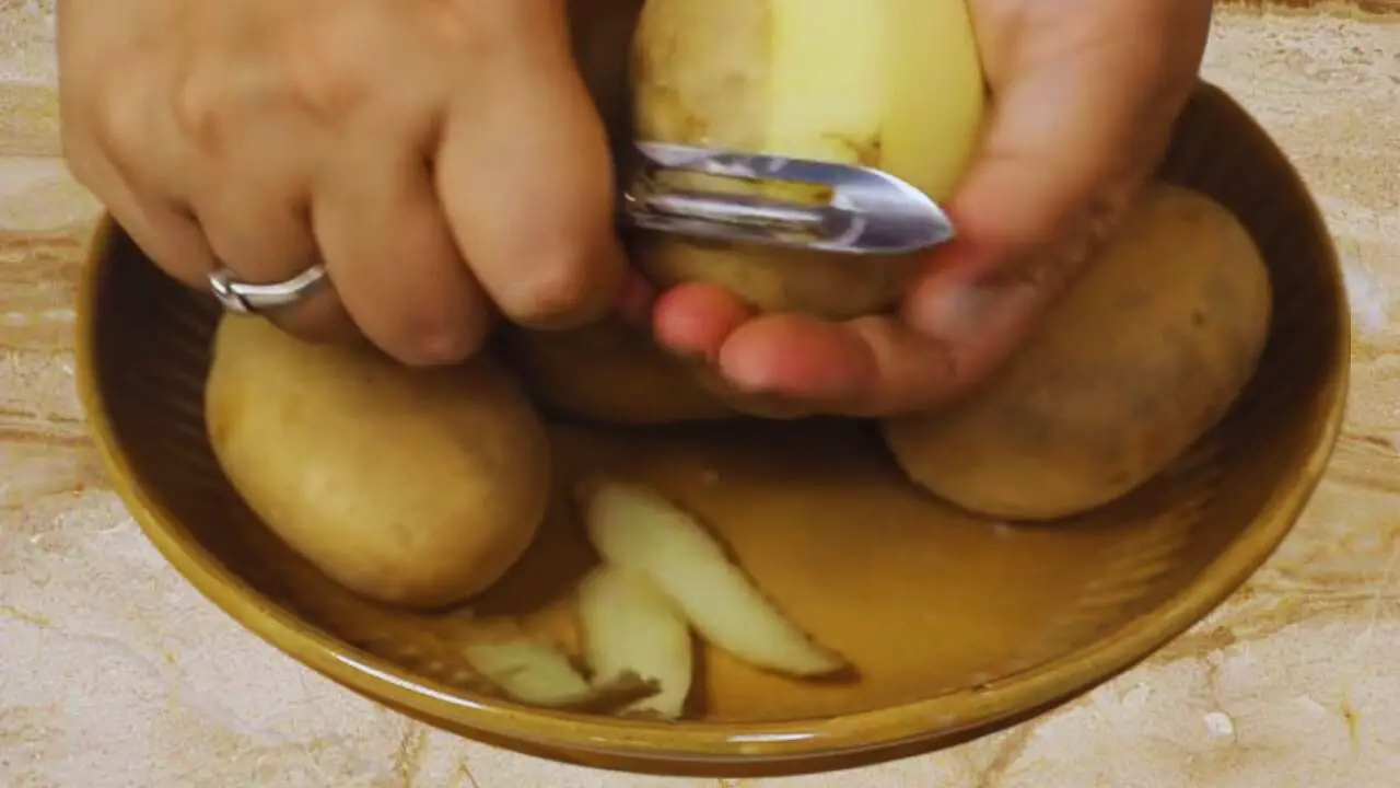 Peeling potato to make French Fries
