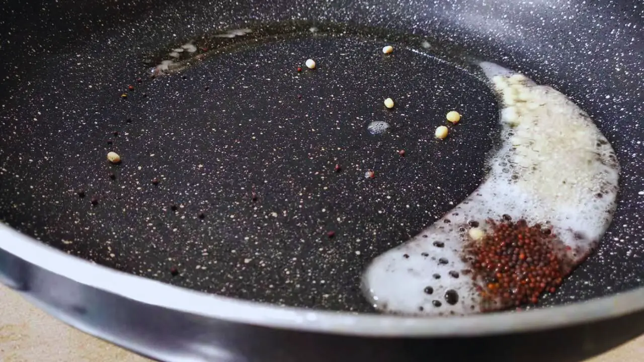 Preparing the tadka for onion tomato chutney