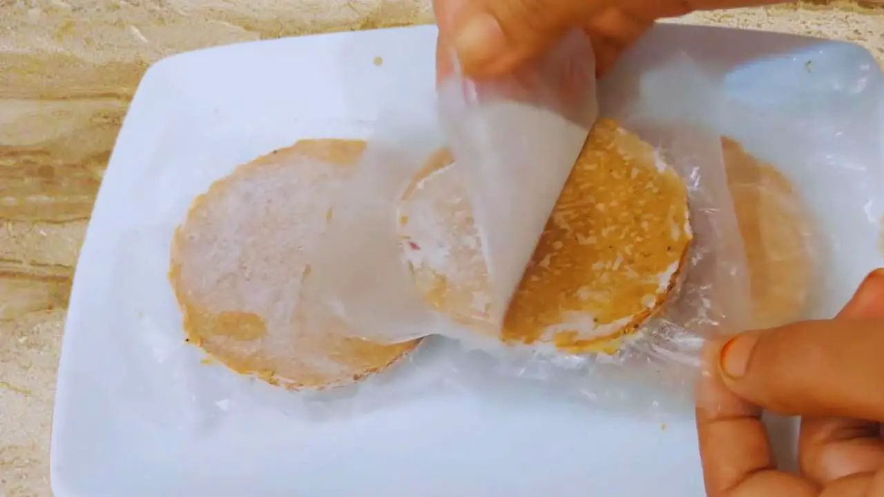 Removing covers from frozen mutton burgers