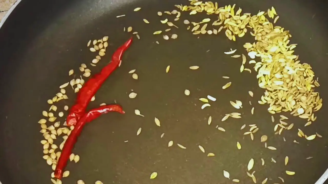 Roasting the spices for making Jalpai Chutney 