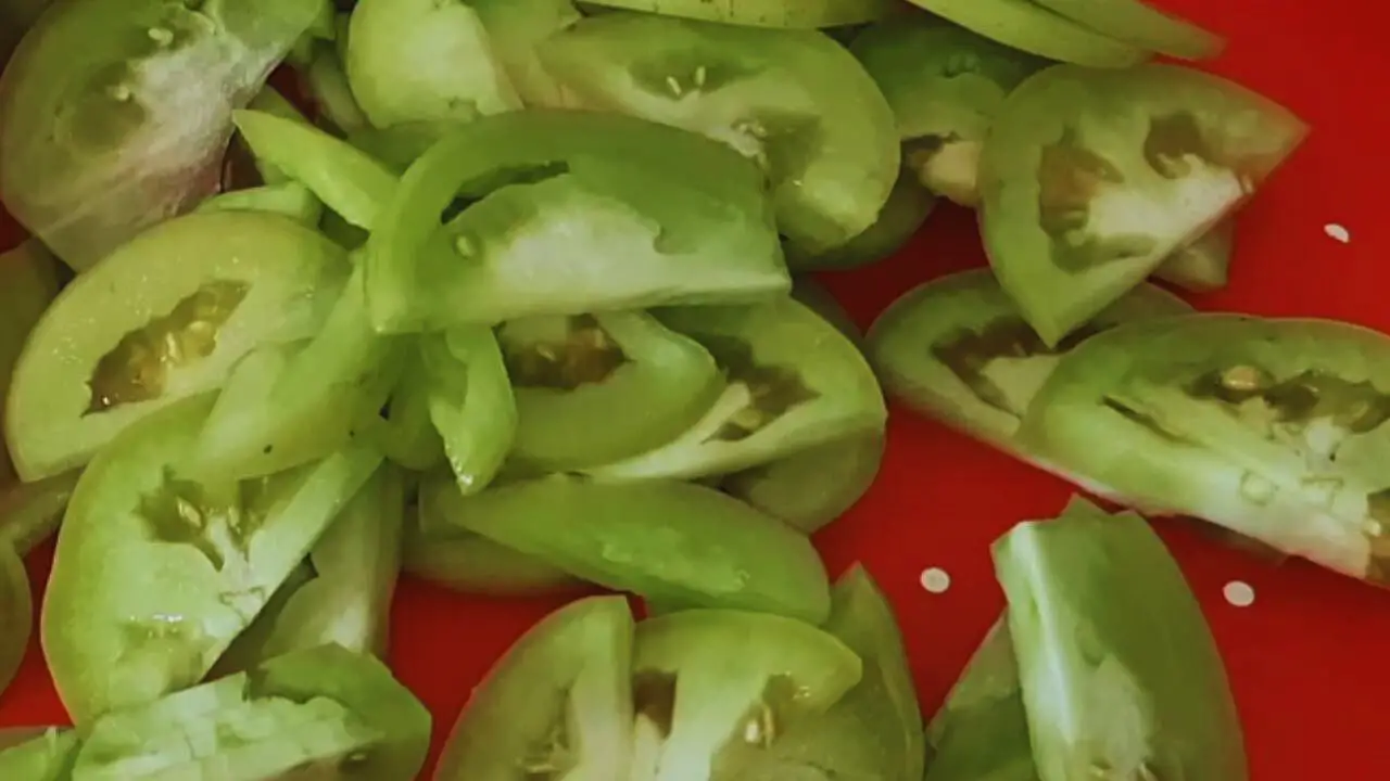 Slicing green tomatoes to make chutney 