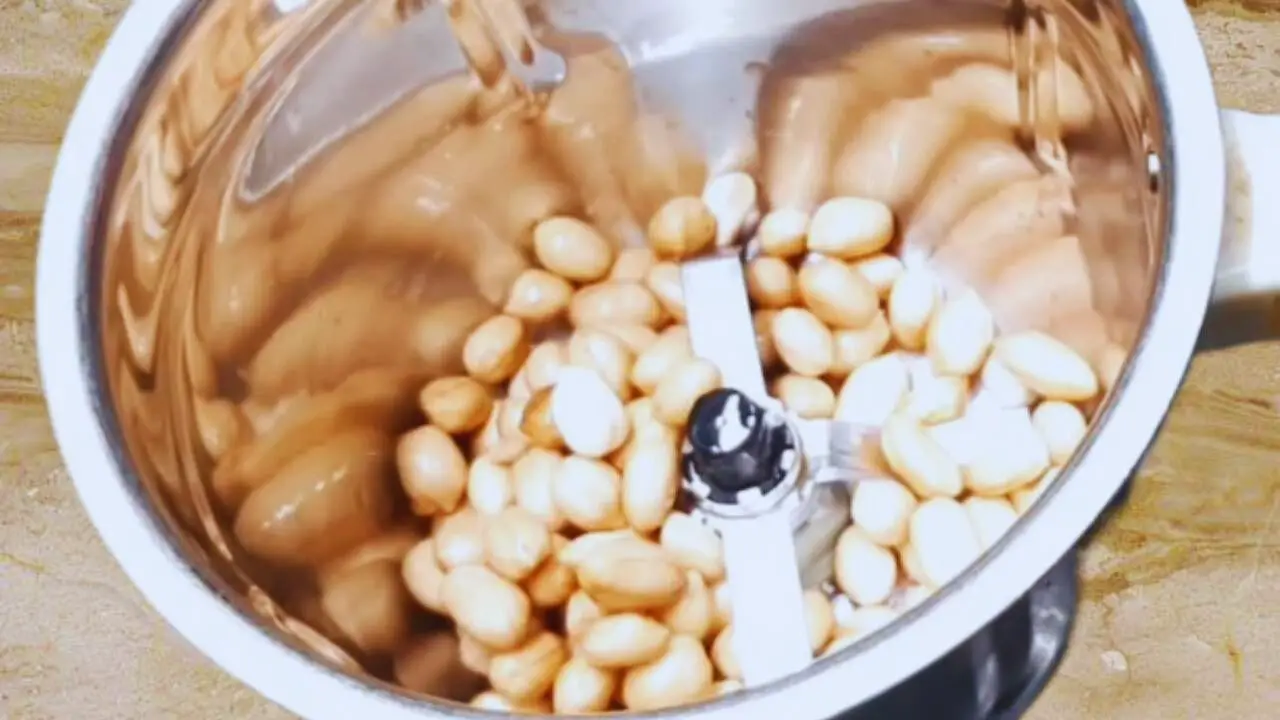 Soaked peanuts in a grinder to make Dahi Chutney