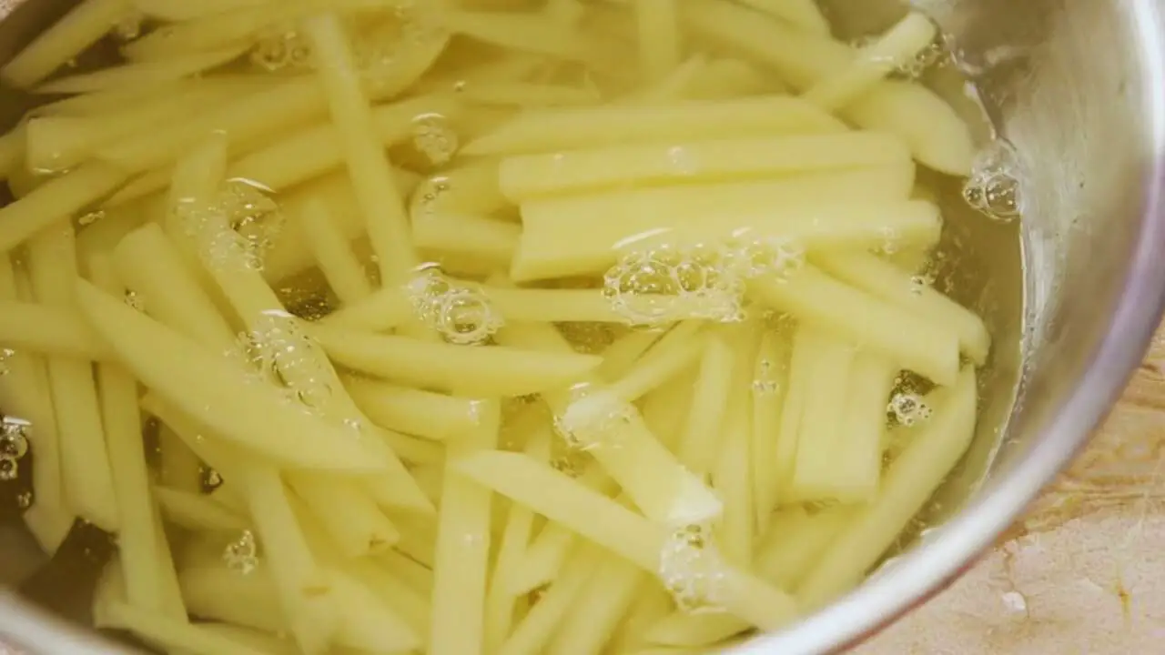 soaking potato finger to make French Fries