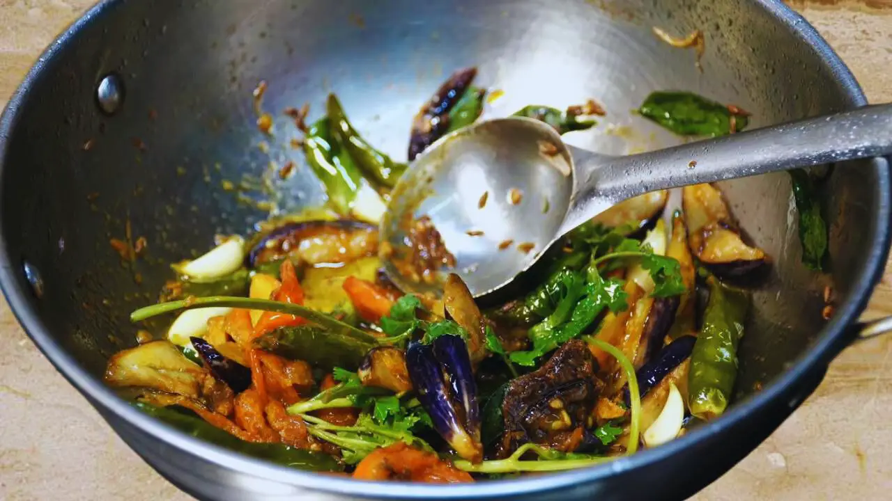 Stirring Brinjal Chutney ingredients 