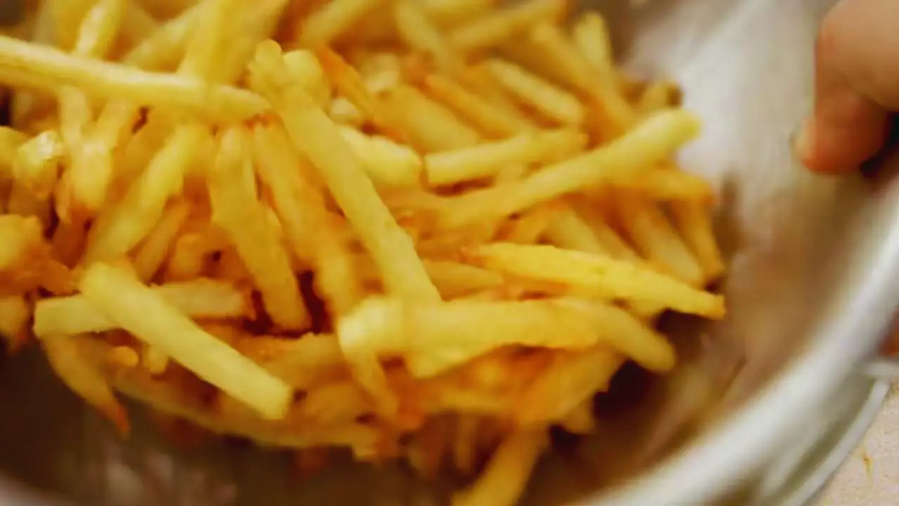 Stirring French Fries in a bowl