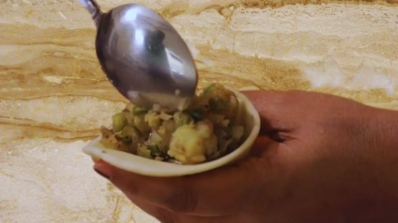Stuffing he cone with Vegetable Samosa mixture 