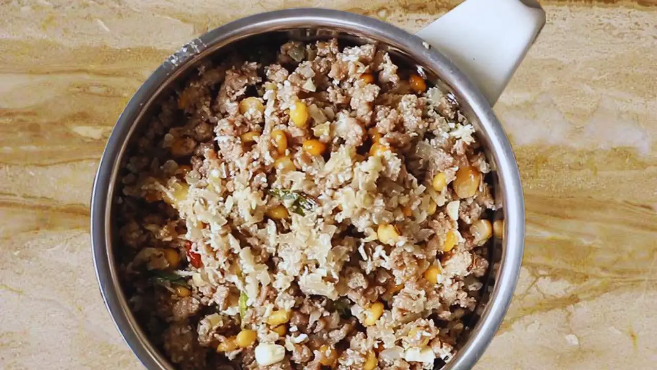 Transferring Mutton Keema Balls mixture to a grinder 