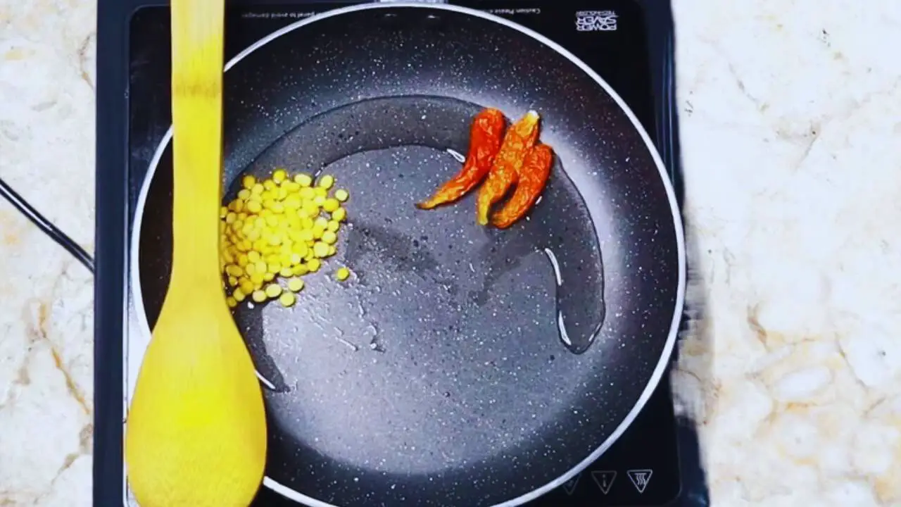 Frying chilies and chana dal 