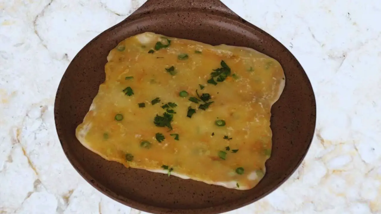 Frying other side of Vegetable Paratha