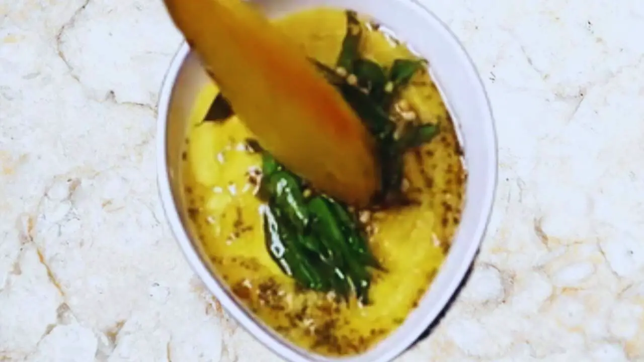 Mixing the tadka with the Sweetcorn Chutney