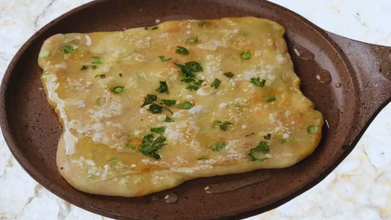 Putting cooking oil on Vegetable Paratha