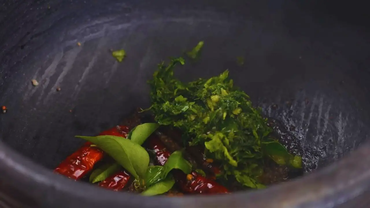Adding green paste and curry leaves 