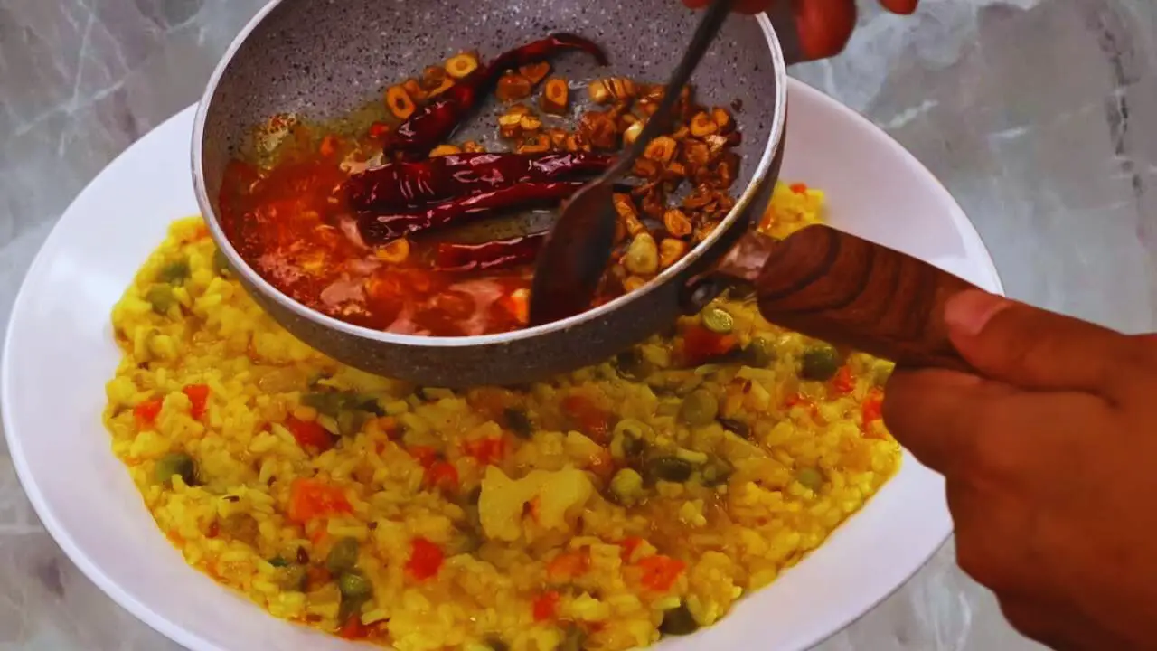 Adding red chili powder to tadka 